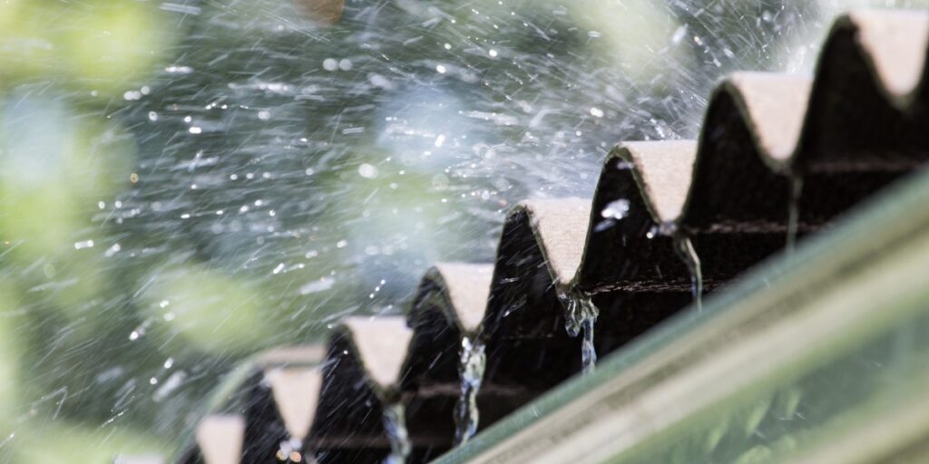 Water flying off roofing tiles.