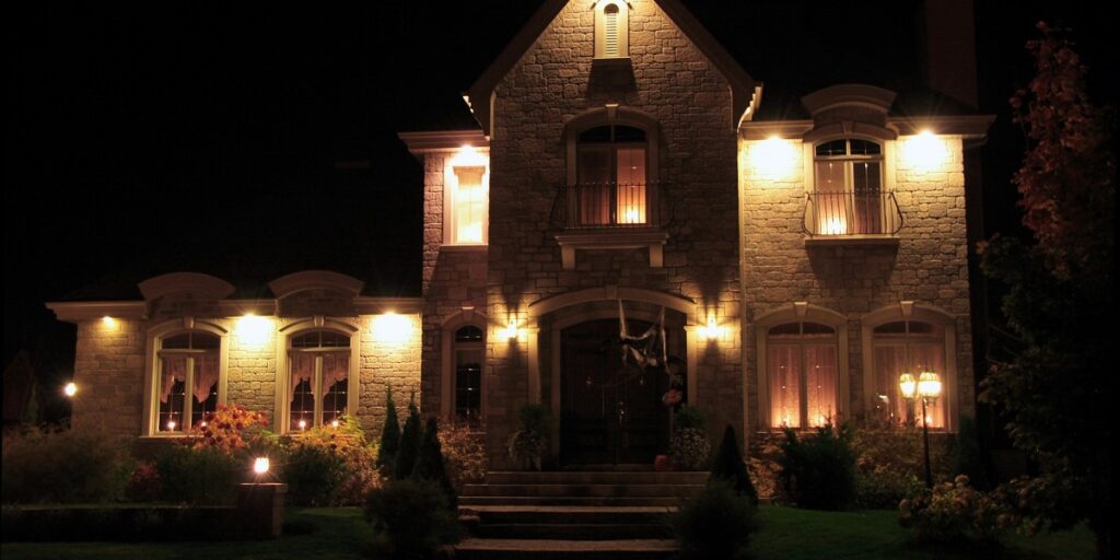 A beautifully lit house with balconies on upper levels.