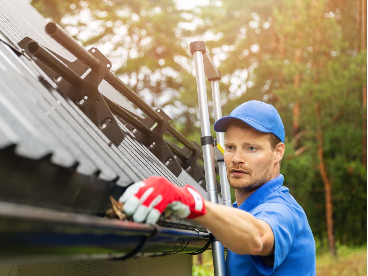 man working on gutters