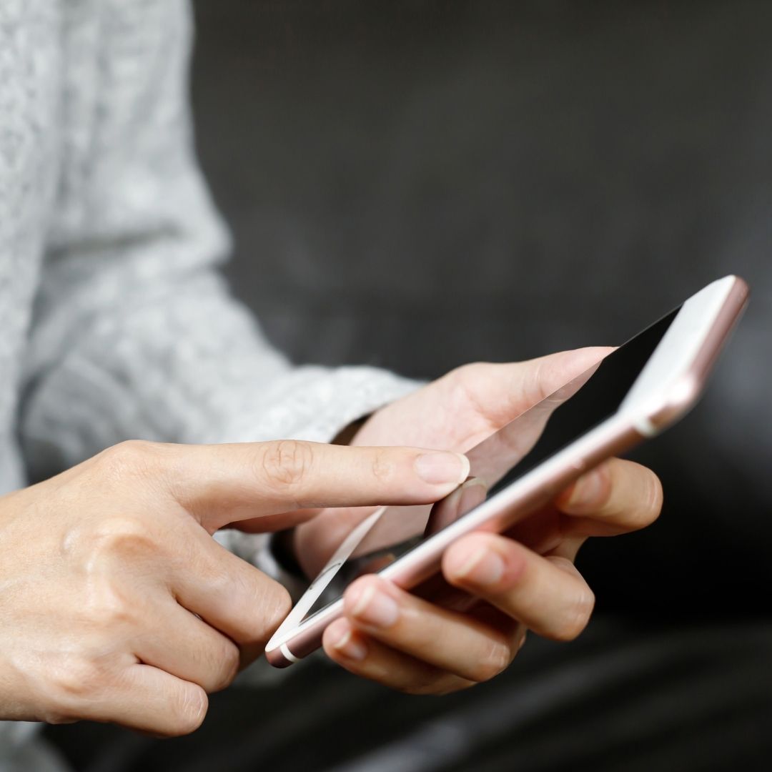 A woman pushing buttons on her iPhone
