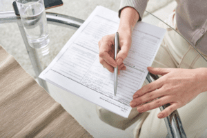 woman filling out an insurance claim form