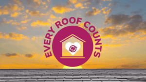 Sunset with a golden sky. The sun is going down behind a black tile roof. A marroon Every Roof Counts logo is on the image. The logo has 'Every Roof Counts' around a marroon circle with a house cut out. Inside the house is a white hard with the Schroeder Roofing logo.